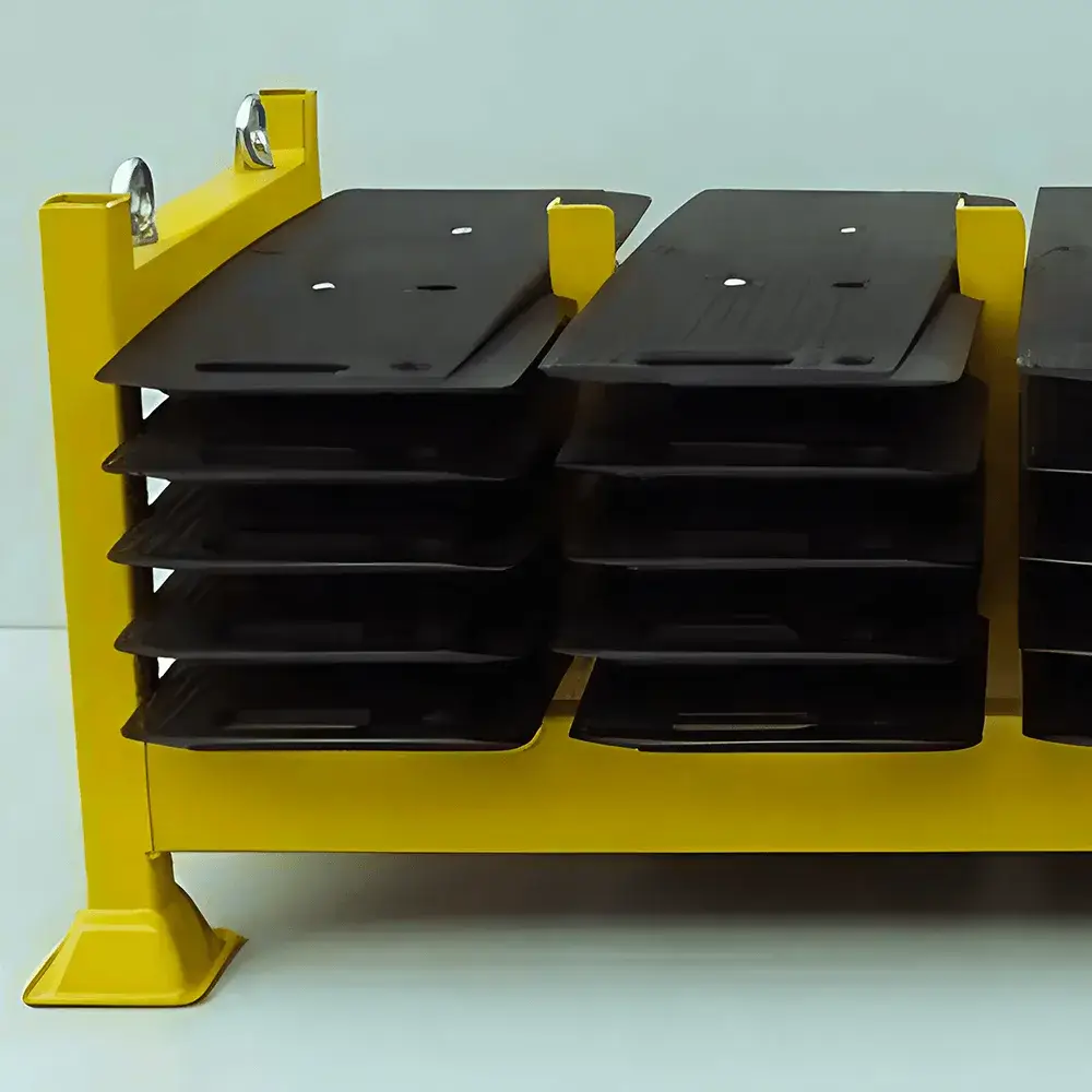 Yellow industrial rack with two stacks of black, slightly curved trench cover. Light background.